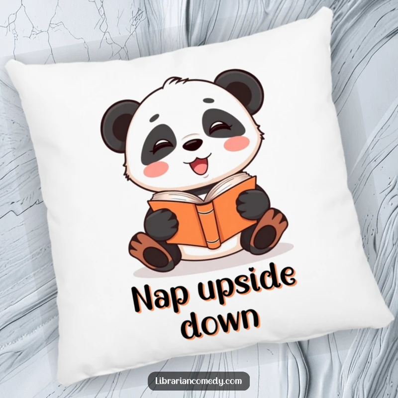 Funny giggling panda reading a book upside down on a decorative pillow, offering comfort and quirky charm, a funny gift.